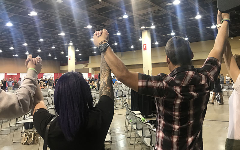 People hold hands in solidarity