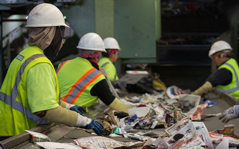 Workers sort through recycled materials at a Phoenix facility.