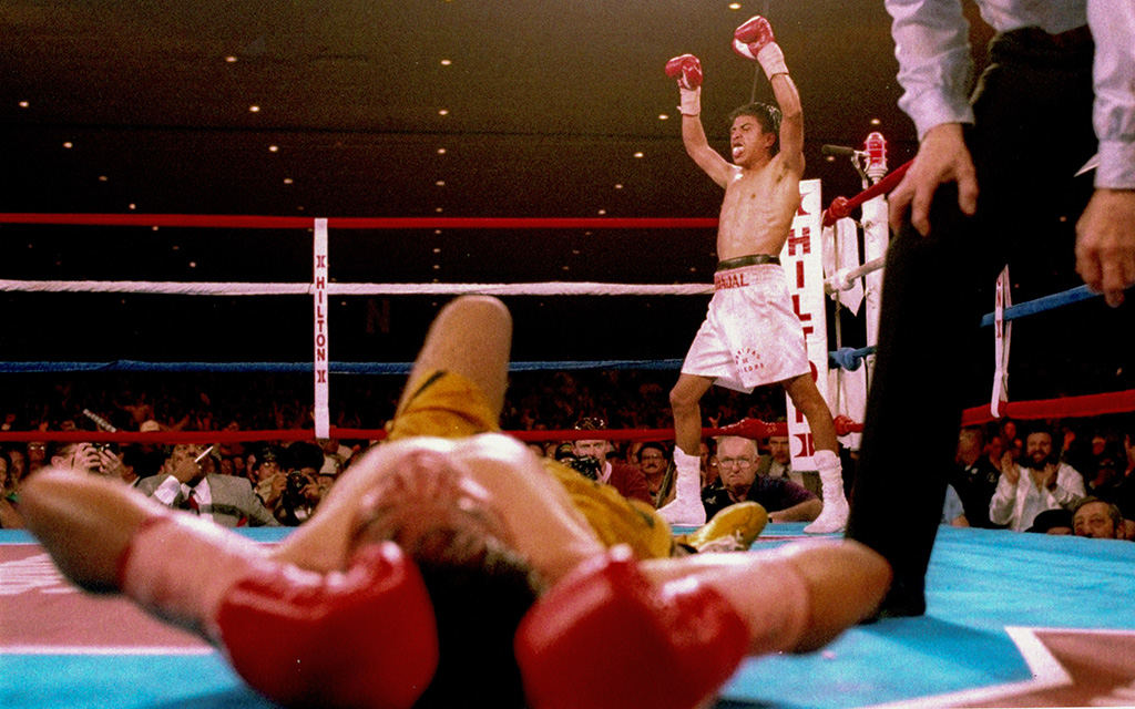 Michael Carbajal celebrates after knocking Humberto “Chiquita” Gonzalez to the canvas in the 1993 Ring Magazine Fight of the Year. Carbajal would win the fight, unifying two junior flyweight titles and earning Ring Magazine’s 1993 Fighter of the Year. (Photo courtesy of Michael Carbajal)