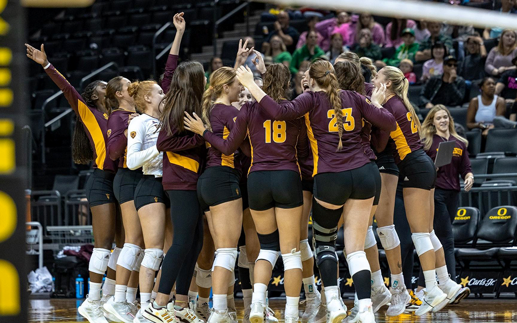 ASU volleyball team celebrating in team huddle.
