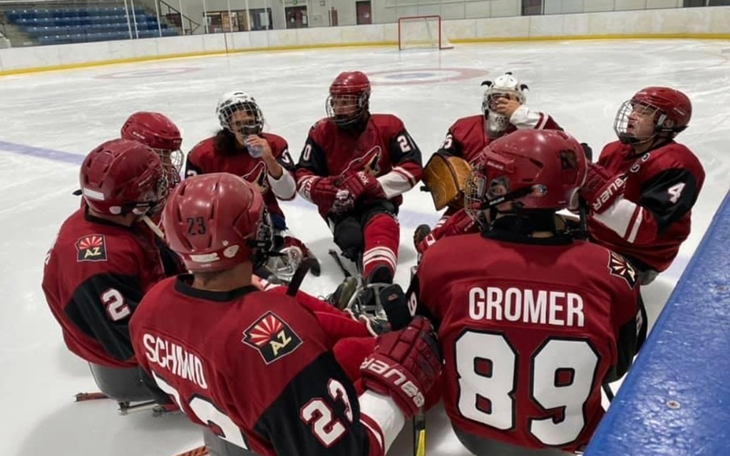 Members of Coyotes Sled Hockey gather for a team huddle at practice, where they exude the spirit of unity and teamwork. (Photo courtesy of Joshua Gromer)