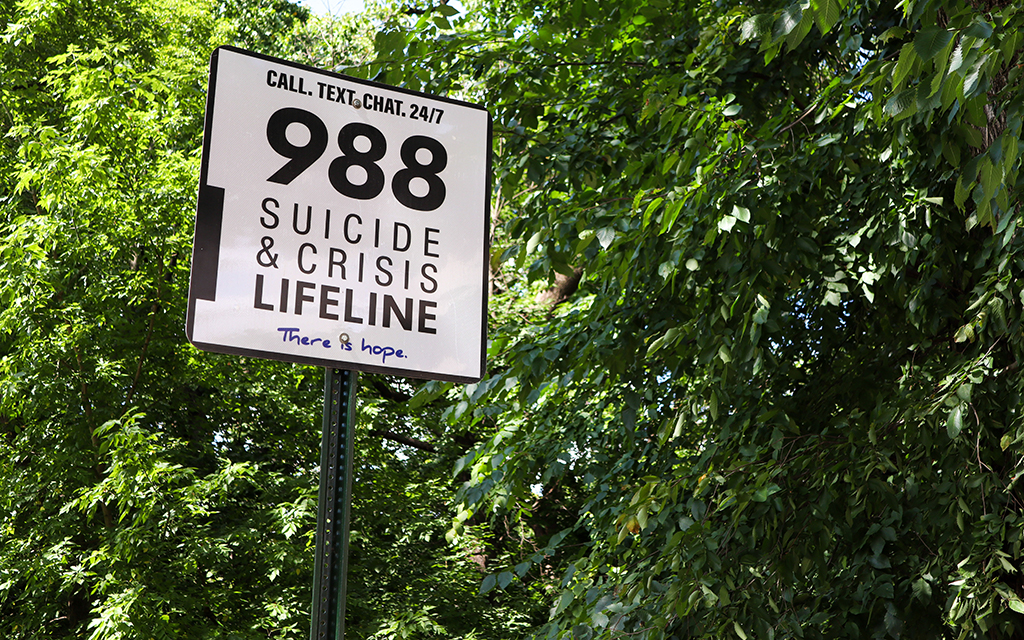 988 Suicide & Crisis Lifeline signs at the William Howard Taft Bridge in Washington, D.C., on July 11, 2024. The city installed anti-suicide barriers and 988 signs along the bridge in 2023. (Photo by Morgan Kubasko/Cronkite News)