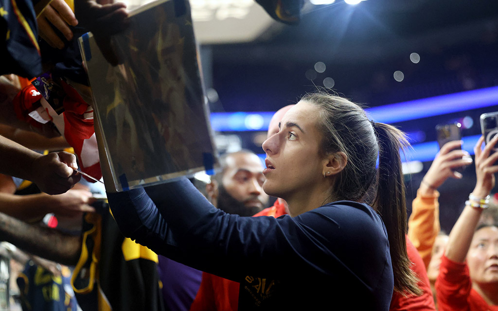 Caitlin Clark, battling a migraine, stops to sign autographs for fans after nearly achieving a triple-double with 15 points, 12 assists and 9 rebounds in the Indiana Fever's 88-82 win Sunday. (Photo by Stella Subasic/Cronkite News)