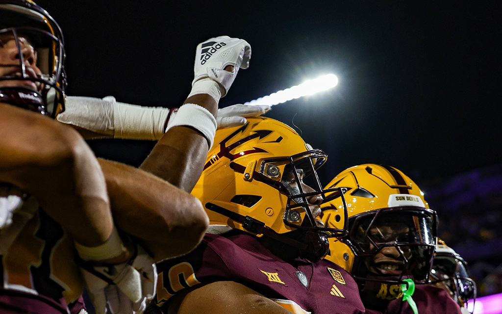 ASU linebacker Zyrus Fiaseu celebrates in the end zone with other ASU football players against Wyoming