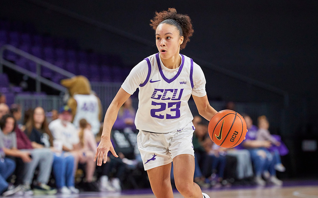 GCU women's basketball player Trinity San Antonio dribbles the ball in the middle of a game.