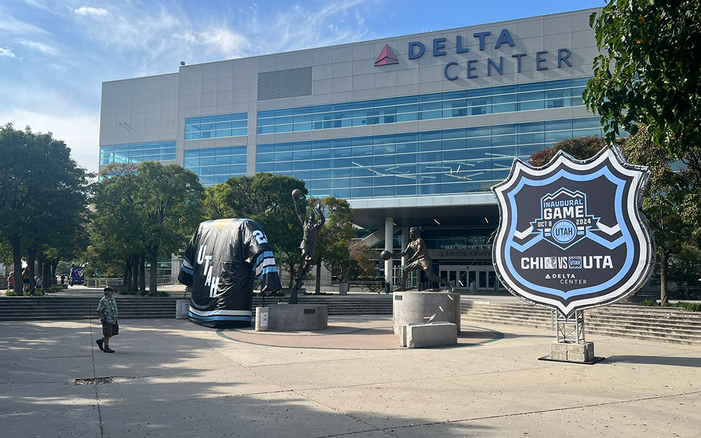 Delta Center building with a large hockey jersey and event sign in front.