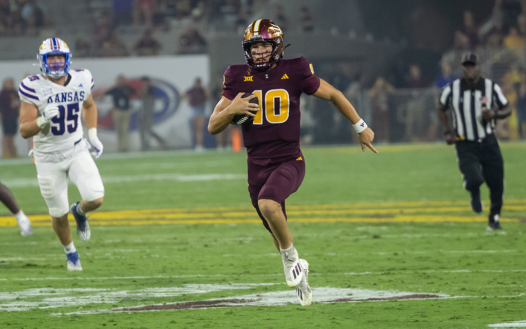 Sam Leavitt in a maroon ASU football uniform running with the ball during the game against Kansas.