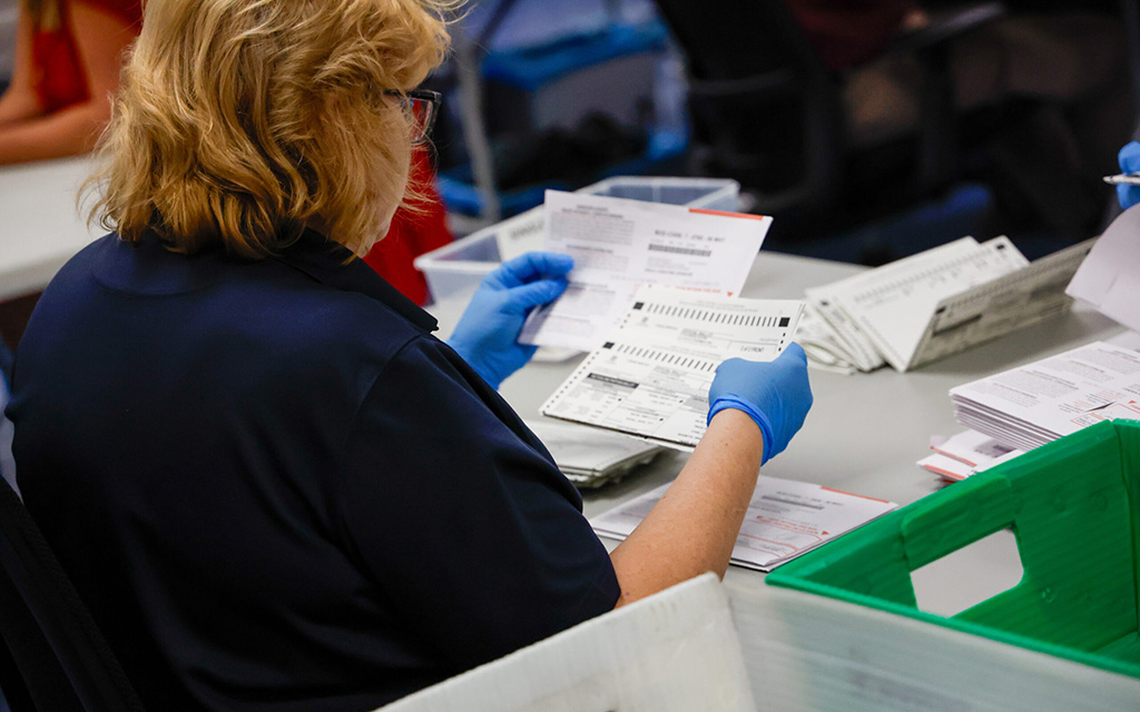 An election worker analyzes a ballot