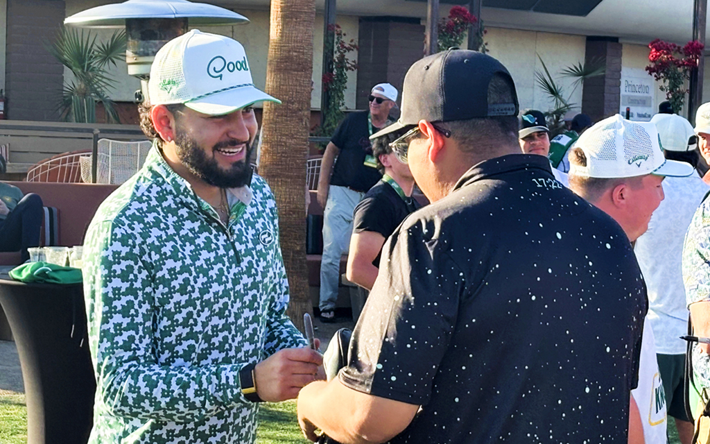 Stephen Castaneda is signing an item for another individual at Good Good GolfNow Desert Knockout.