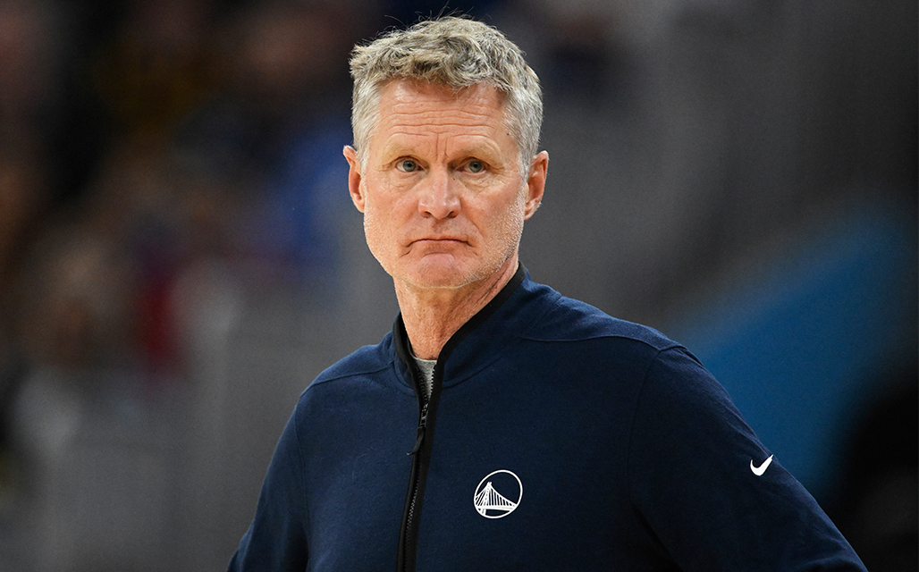Coach in blue warriors jacket looking angry