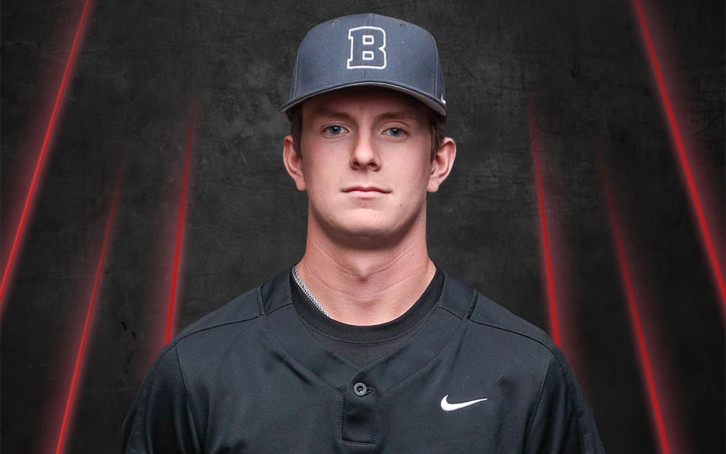 Person in a black baseball uniform and gray cap with a "B" logo, set against a dark background with red diagonal streaks.
